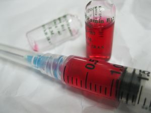A vial of Vitamin B12 with syringe